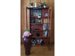 Display cabinet with ornaments and vase