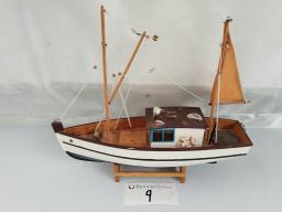 A charming and realistic model of a traditional fishing boat, crafted with attention to nautical detail